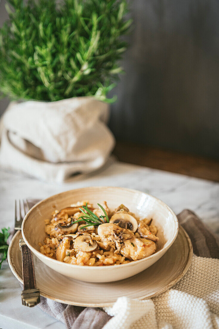 Chicken and mushroom risotto, served on a marble kitchen top