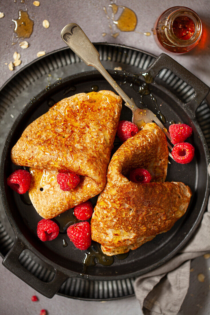 North Staffordshire oatcake pancake served with raspberries and golden syrup