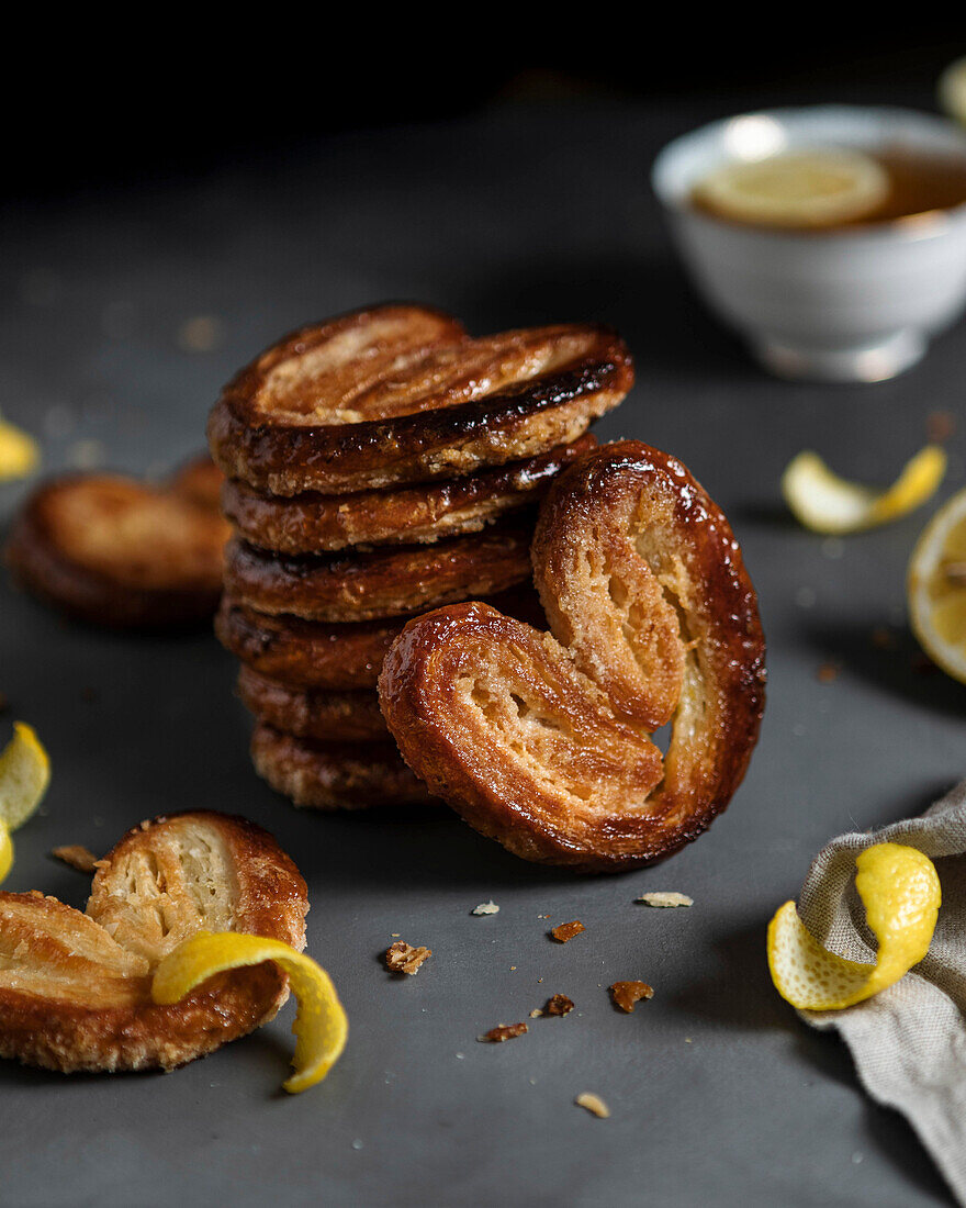 Lemon Palmiers, made from puff pastry on a dark background