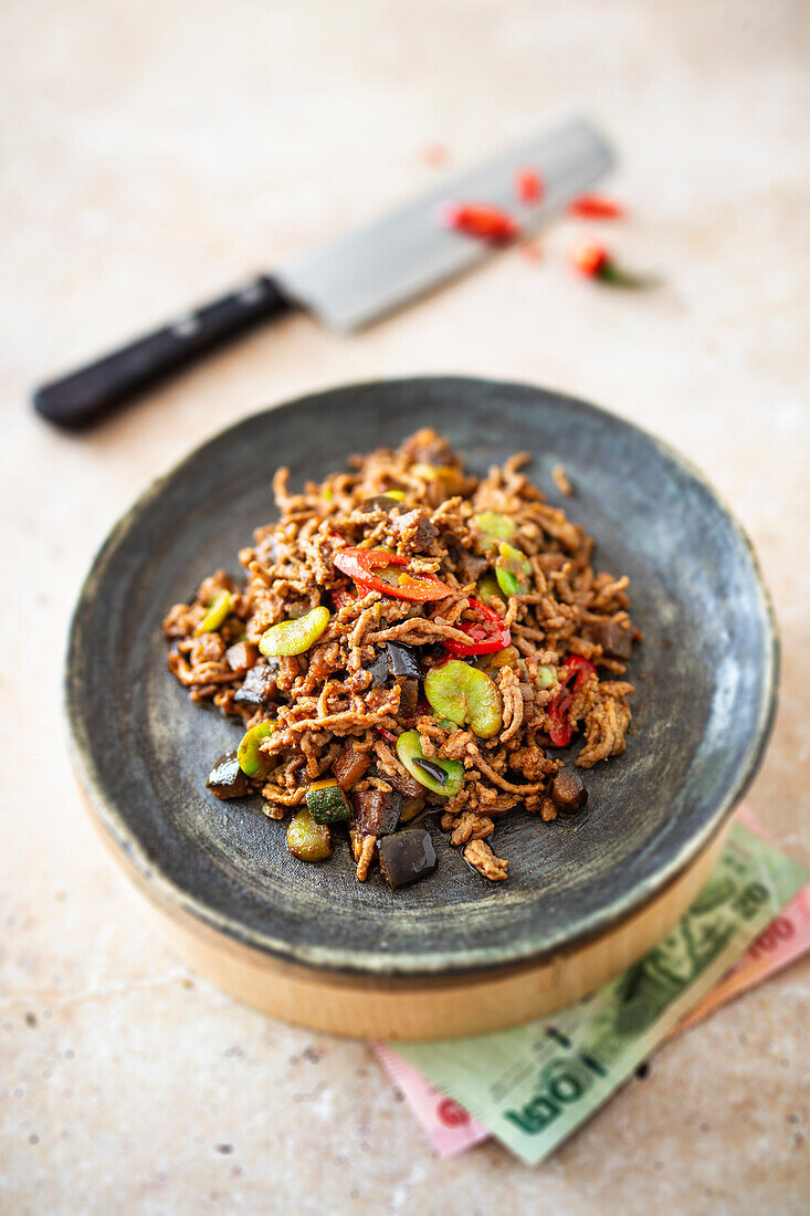 Fried pork with bitter beans and Nam Prik Pau