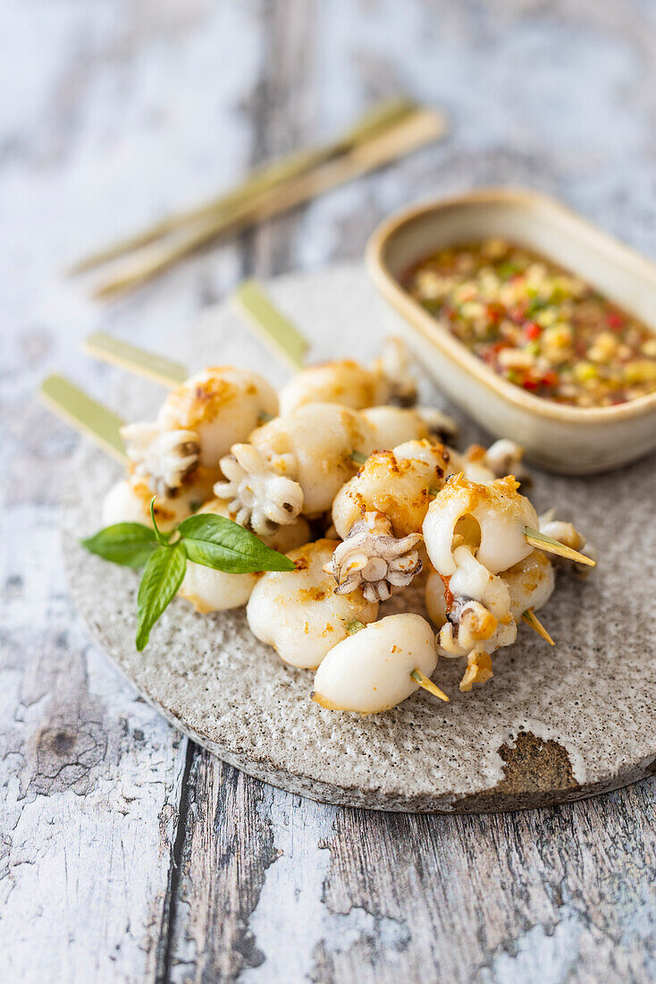Grilled baby squid with spicy dip (southern Thailand)