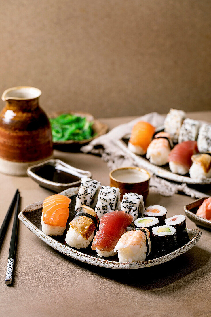 Sushi rolls set for two, traditional japanese dish sushi and rolls with fresh salmon, tuna, eel and prawns on rice