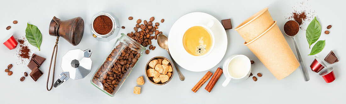 Coffee composition with coffee and accessories on white background, banner, top view