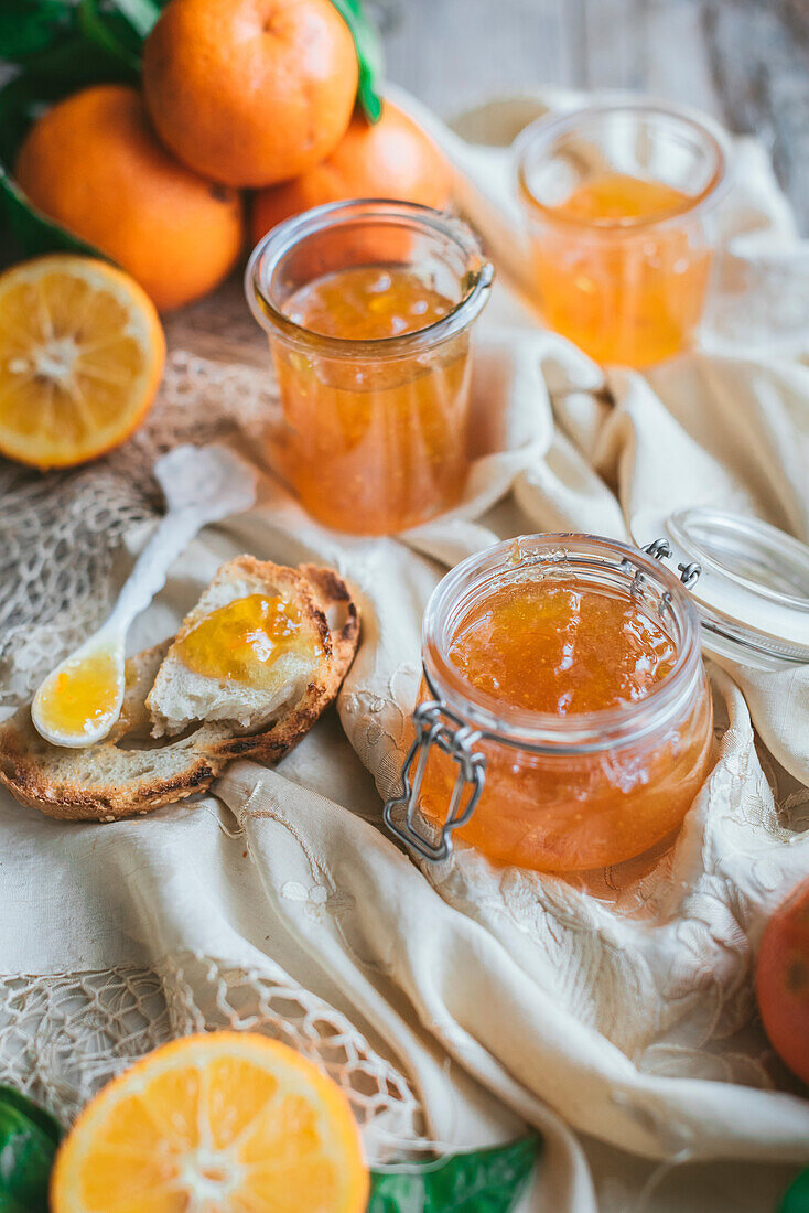 Homemade Seville Orange Marmalade in a jar with sliced oranges