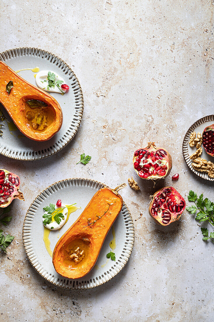 Arranged plate of scrumptious roasted halved pumpkin with sauce and oil on ceramic plate