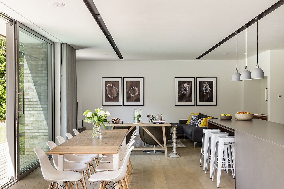 Open kitchen with counter and dining area with modern chairs