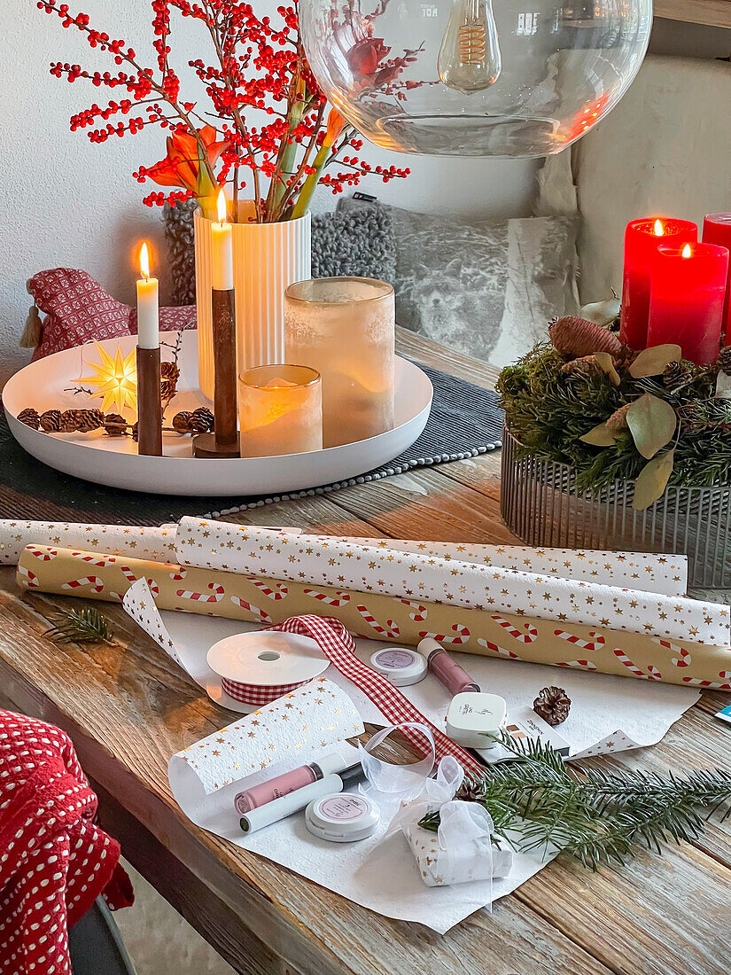 Christmas wrapping station set up on a wooden table