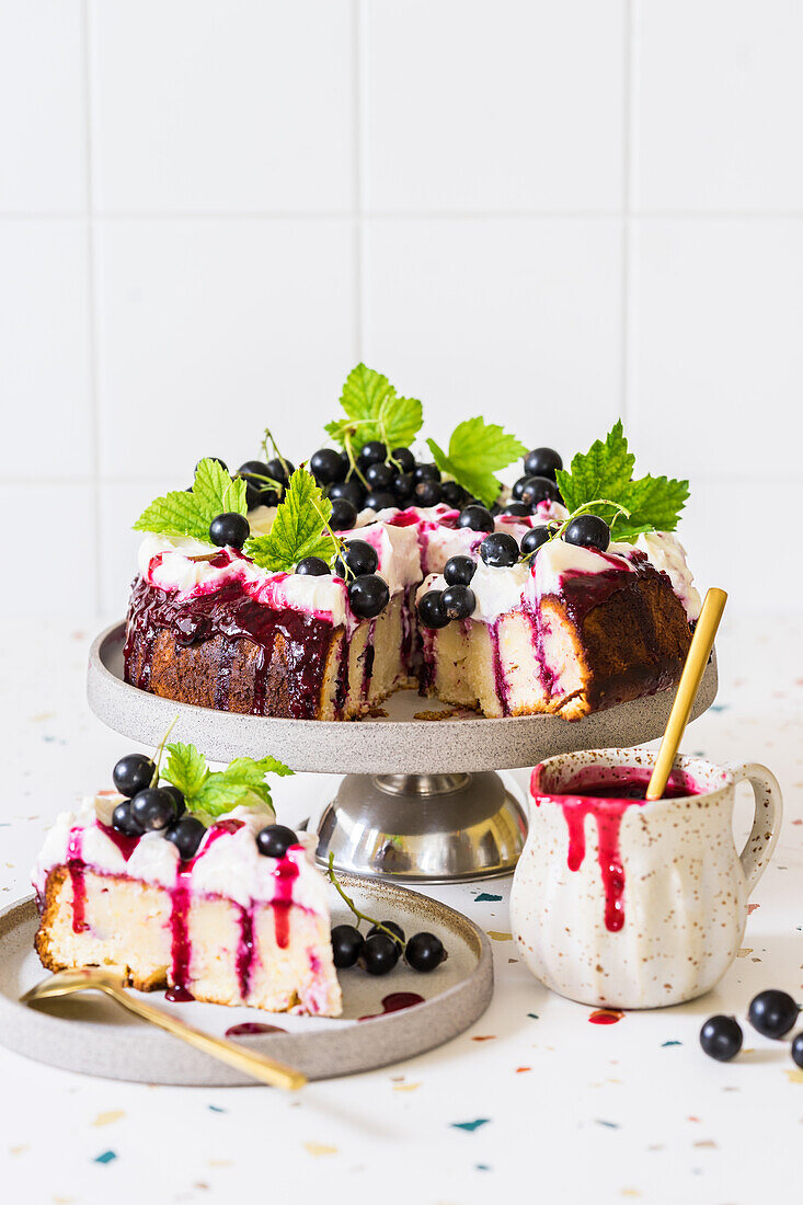 Blackcurrant and lemon poke cake with cream cheese frosting and blackcurrant sauce