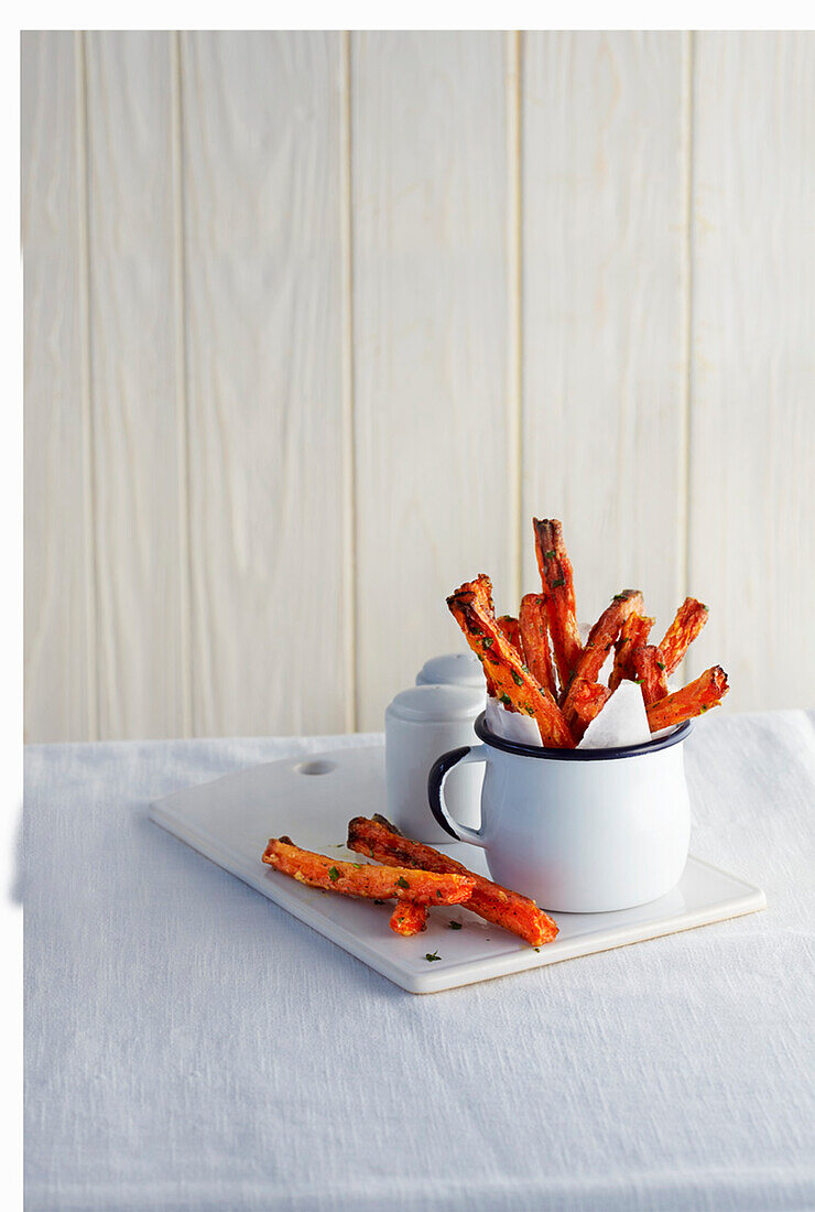 Thin carrot fries in an enamel cup