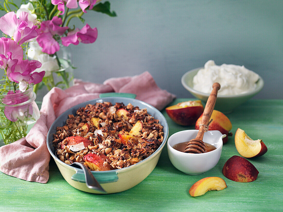 Baked nectarines with nut crumble and whipped cream