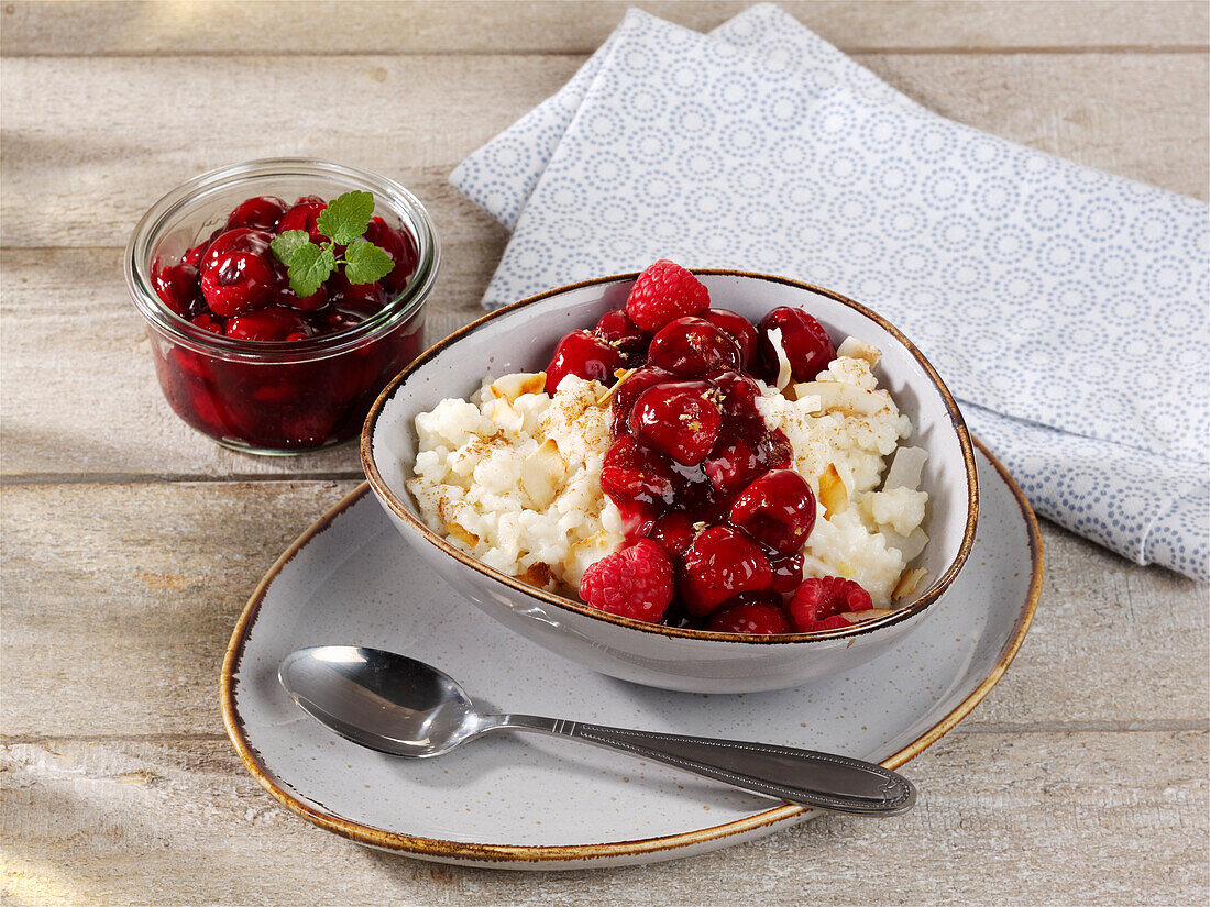 Coconut milk rice with sour cherry and raspberry compote