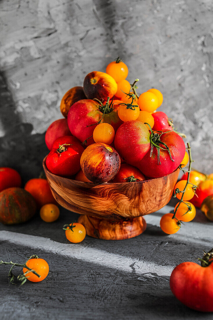 Freshly harvested tomatoes in a wooden bowl