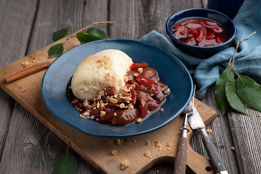 Vegan yeast dumpling with plum compote and muesli topping