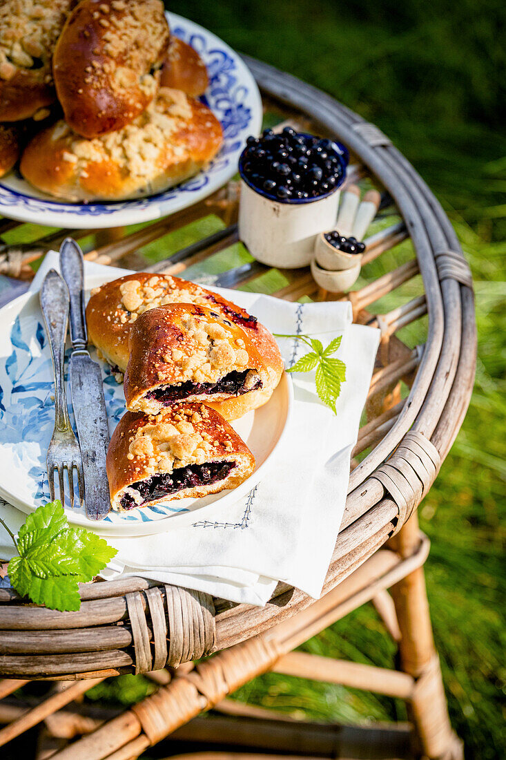 Pastry with blackcurrants on garden table