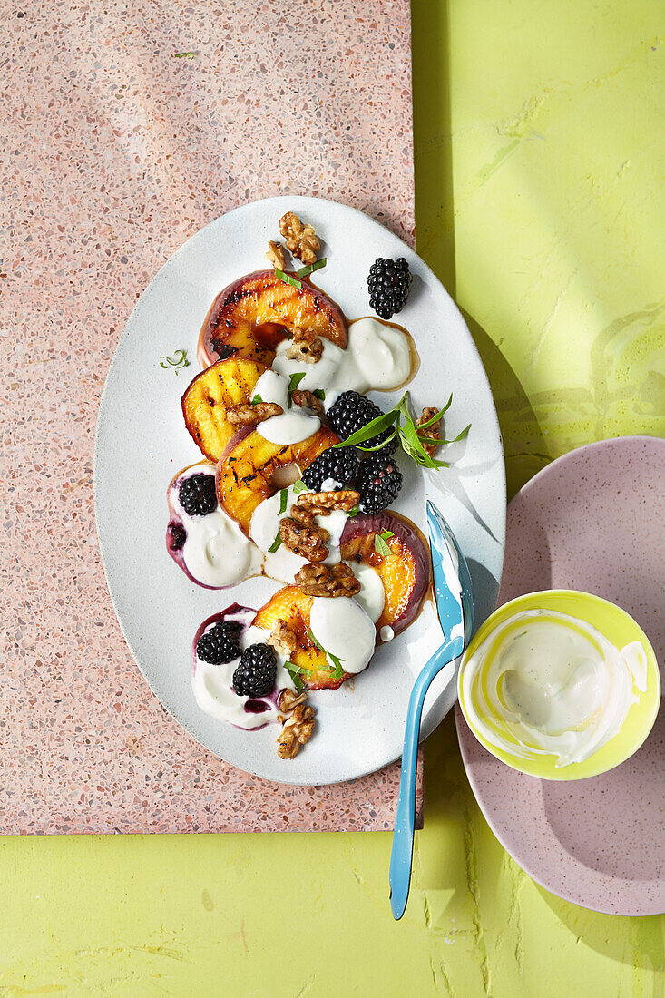 Baked peaches with yoghurt, blackberries and caramelised walnuts