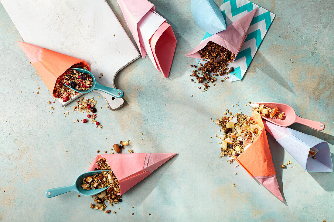 Four types of granola in paper cones