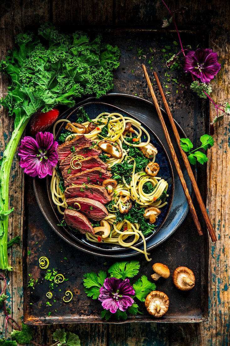 Beef teriyaki with noodles, shiitake mushrooms, and cabbage