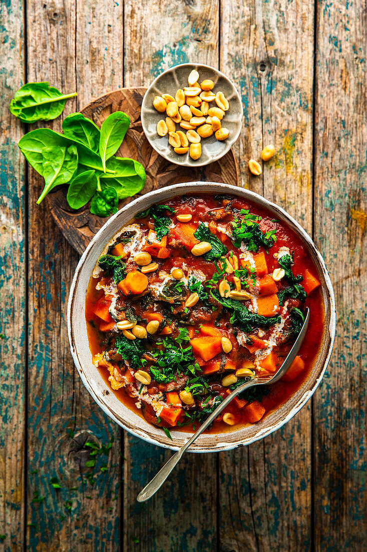 Vegan peanut stew with sweet potatoes and spinach