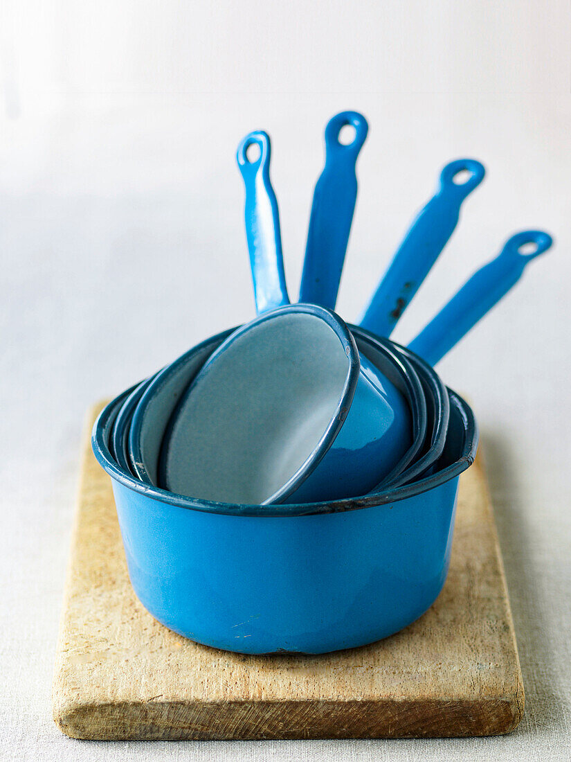 Blue pots on wooden cutting board