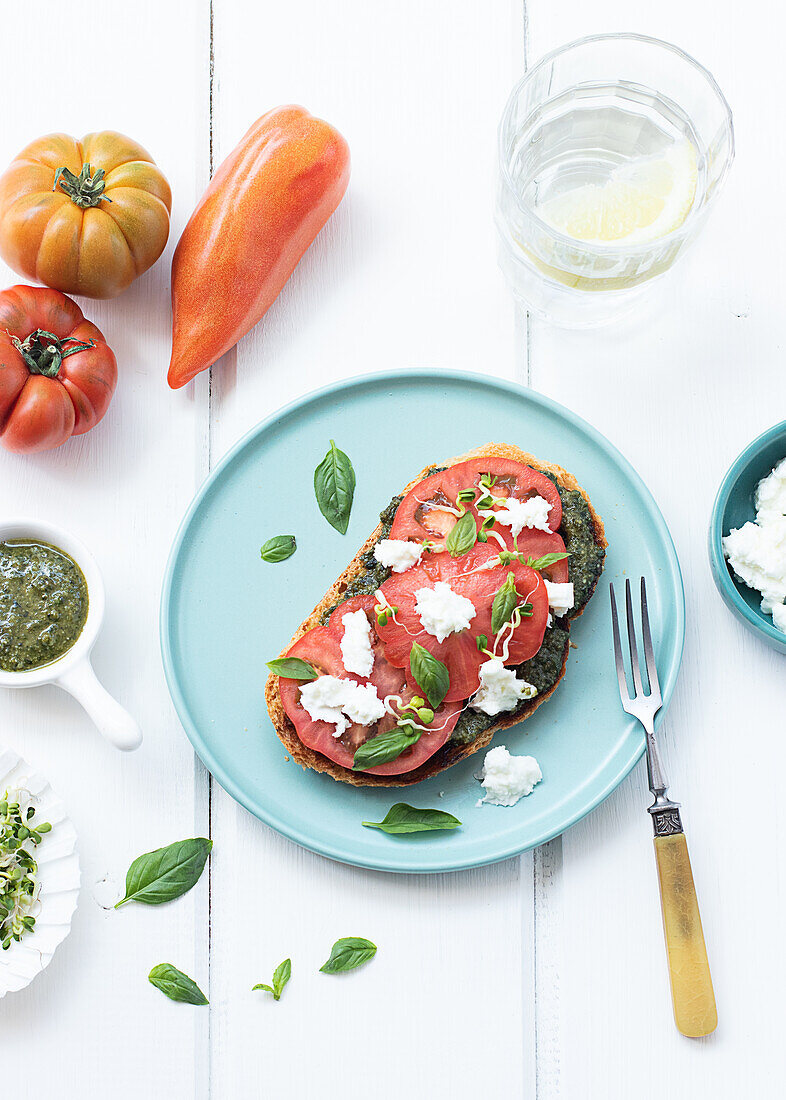 Top view of caprese toast served on wooden table