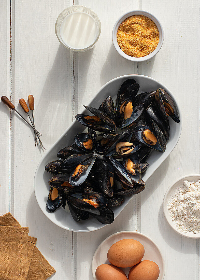 Top view of fresh appetizing mussels with stuffed ingredients served on white table