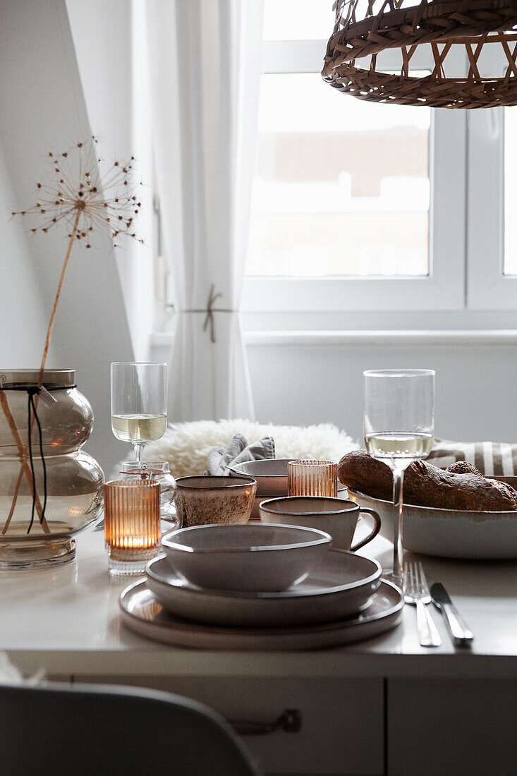 White kitchen table with dishes in beige tones