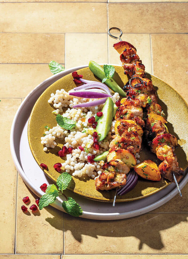 Sticky citrus chicken and fruit kebabs with couscous