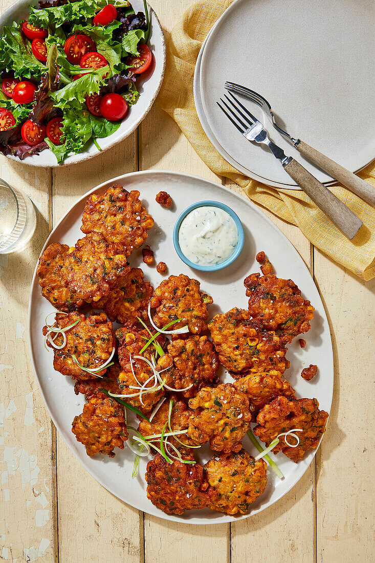 Corn fritters with dip and salad