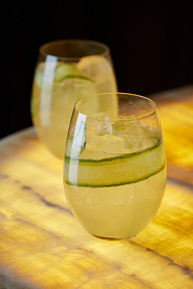 Cooler with cucumber strips and ice cubes