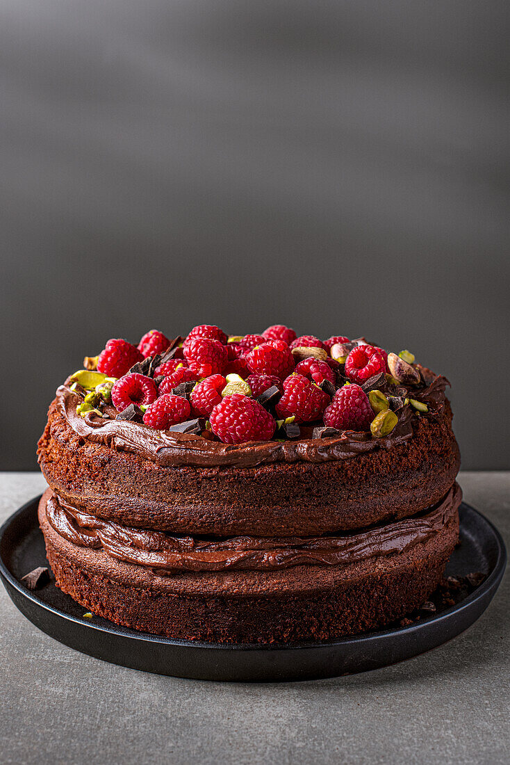 Raspberry chocolate cake with dark ganache and pistachios