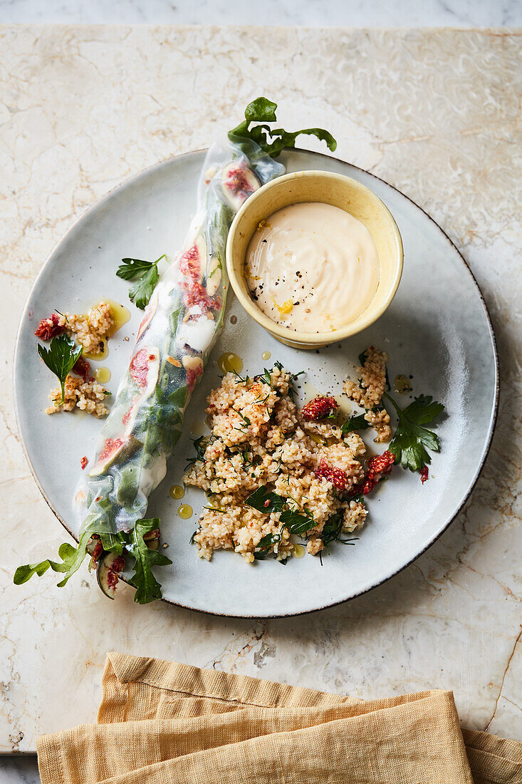 Goat cheese and fig rolls with lemon dip and spicy bulgur salad