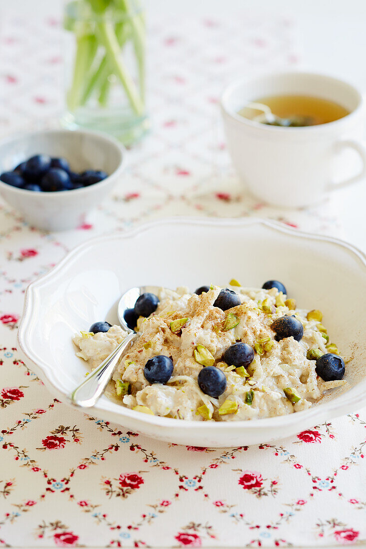Overnight oats with blueberries, pistachios and green tea
