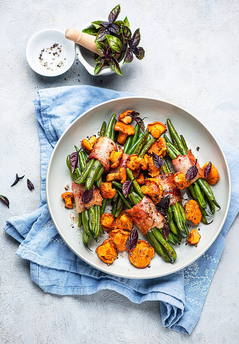 Green bean bundles wrapped in bacon with chanterelles