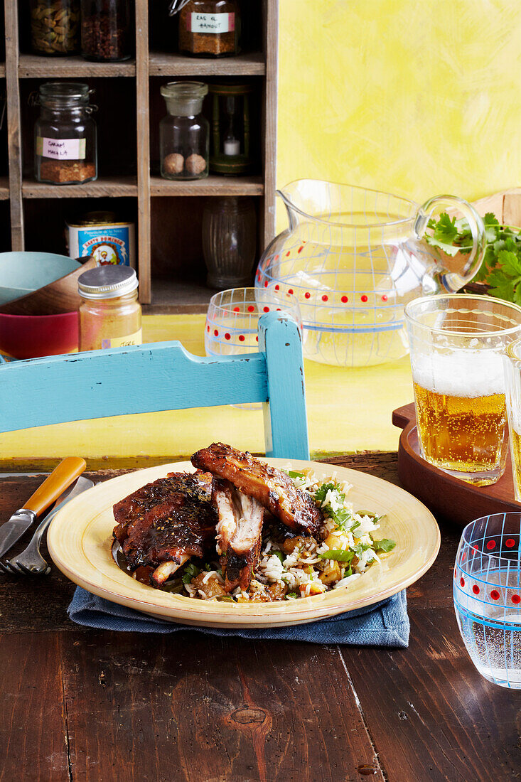 Sticky jerk ribs with brown sugar served on pineapple rice