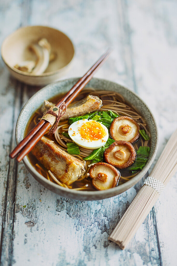 Japanese soup with soba noodles, shiitake mushrooms and ribs