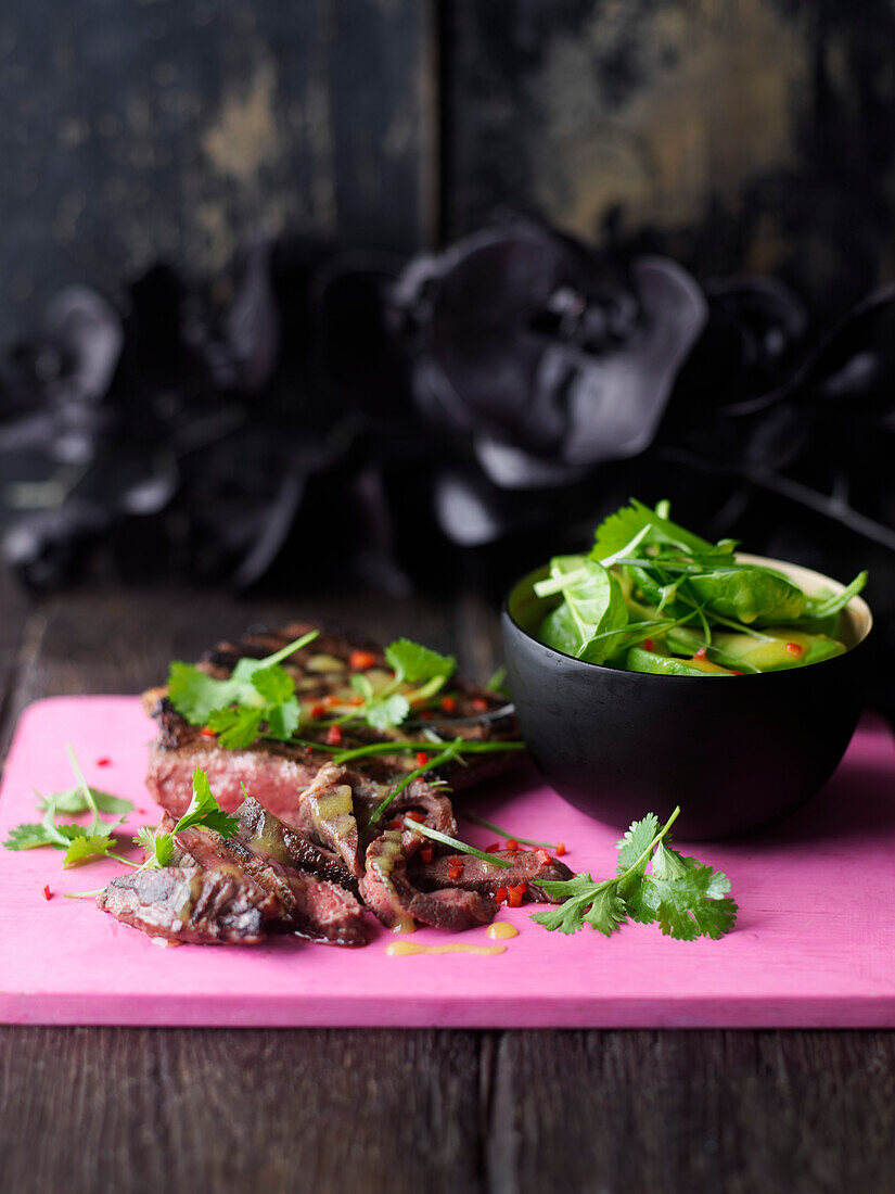 Grilled steak served with cilantro salad with mango vinaigrette