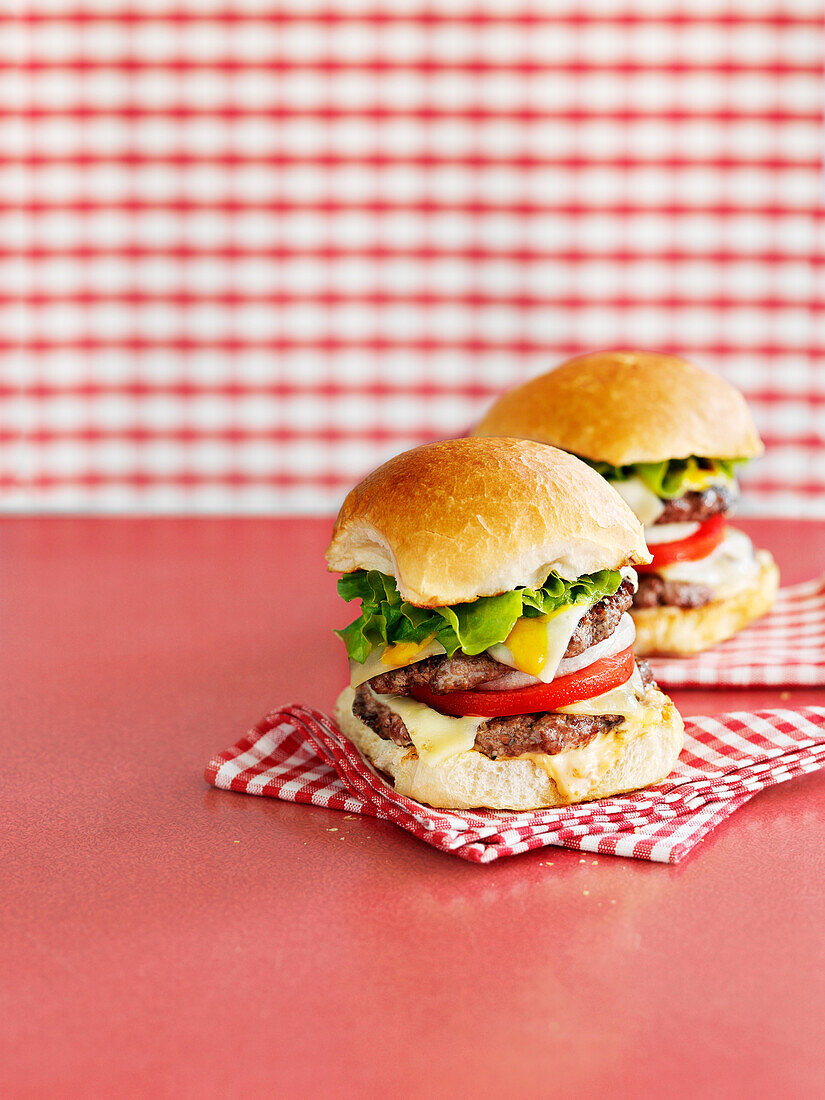 Cheeseburger on red and white checked napkins