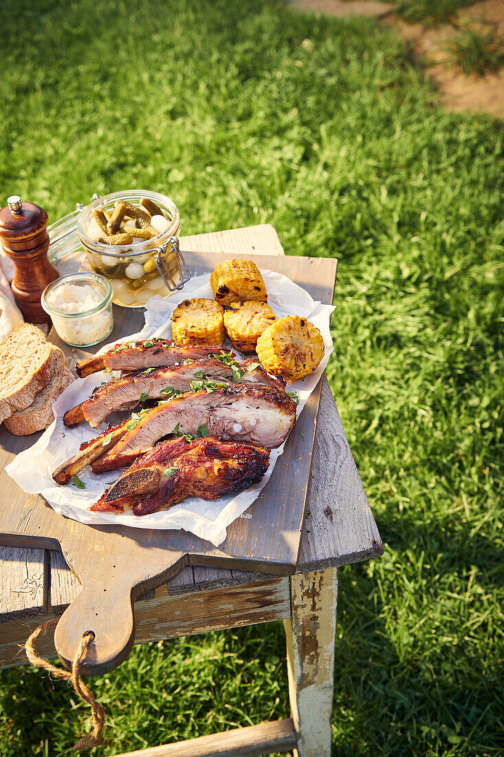 Grilled pork ribs with sweet chili glaze and corn on the cob