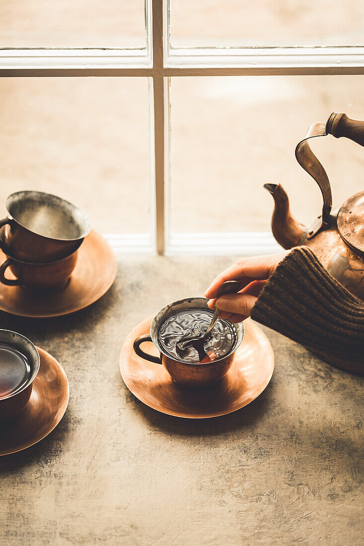 Vintage tea kettle and tea in tea cups
