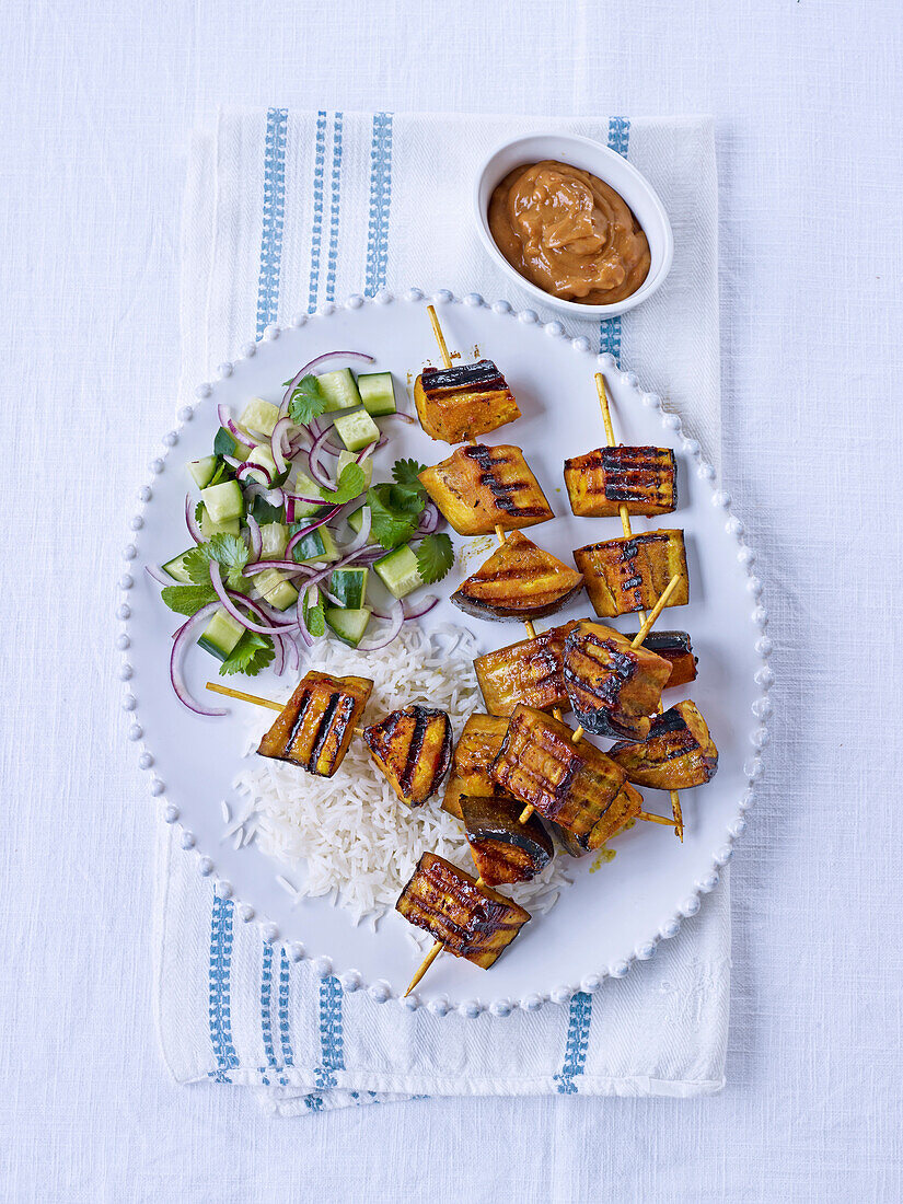 Grilled aubergine satay kebabs with a cucumber salad and peanut sauce