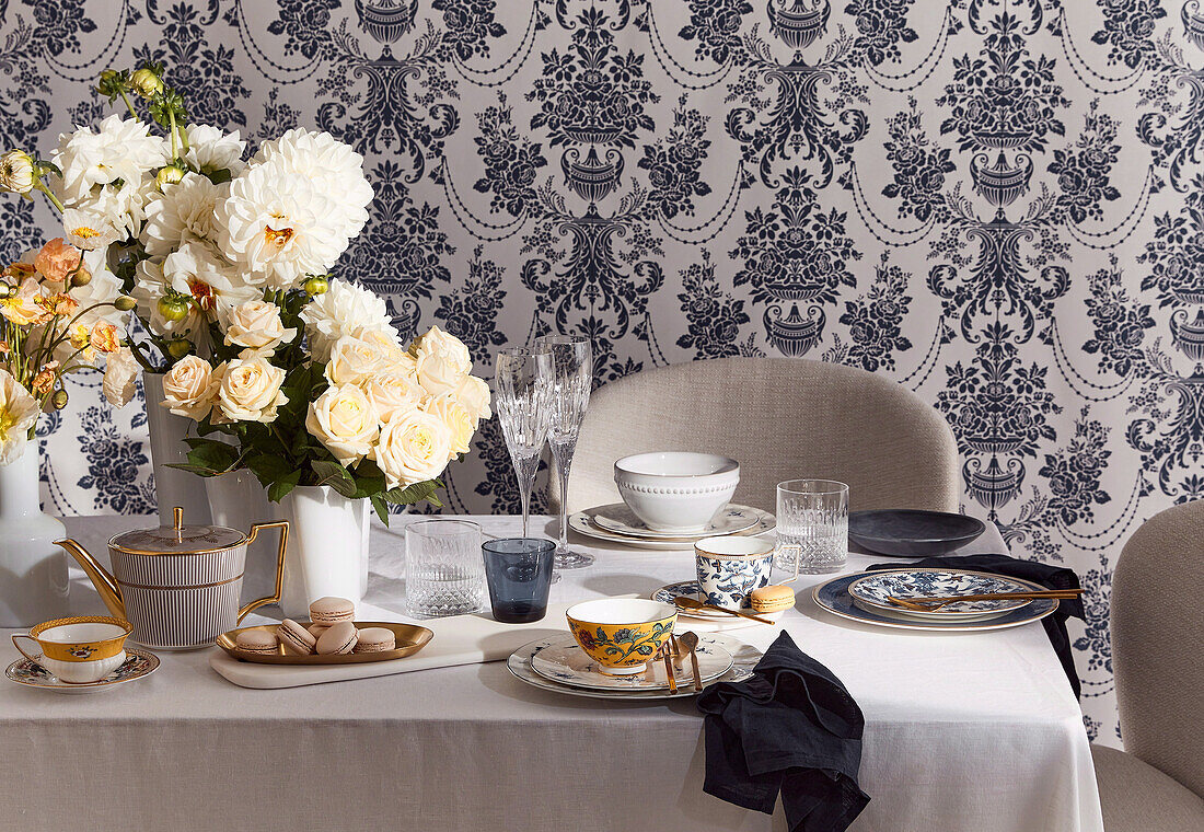 Laid tea table decorated with flowers