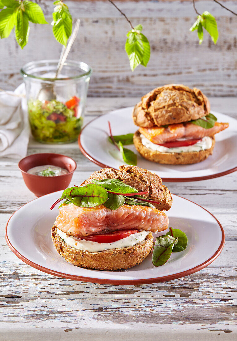 Burger with salmon, mayonnaise, and tomato