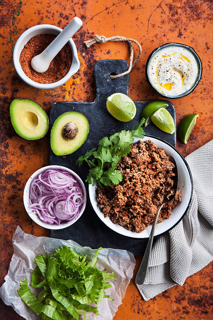 For tacos, minced meat, onion, salad, lime, coriander and avocado