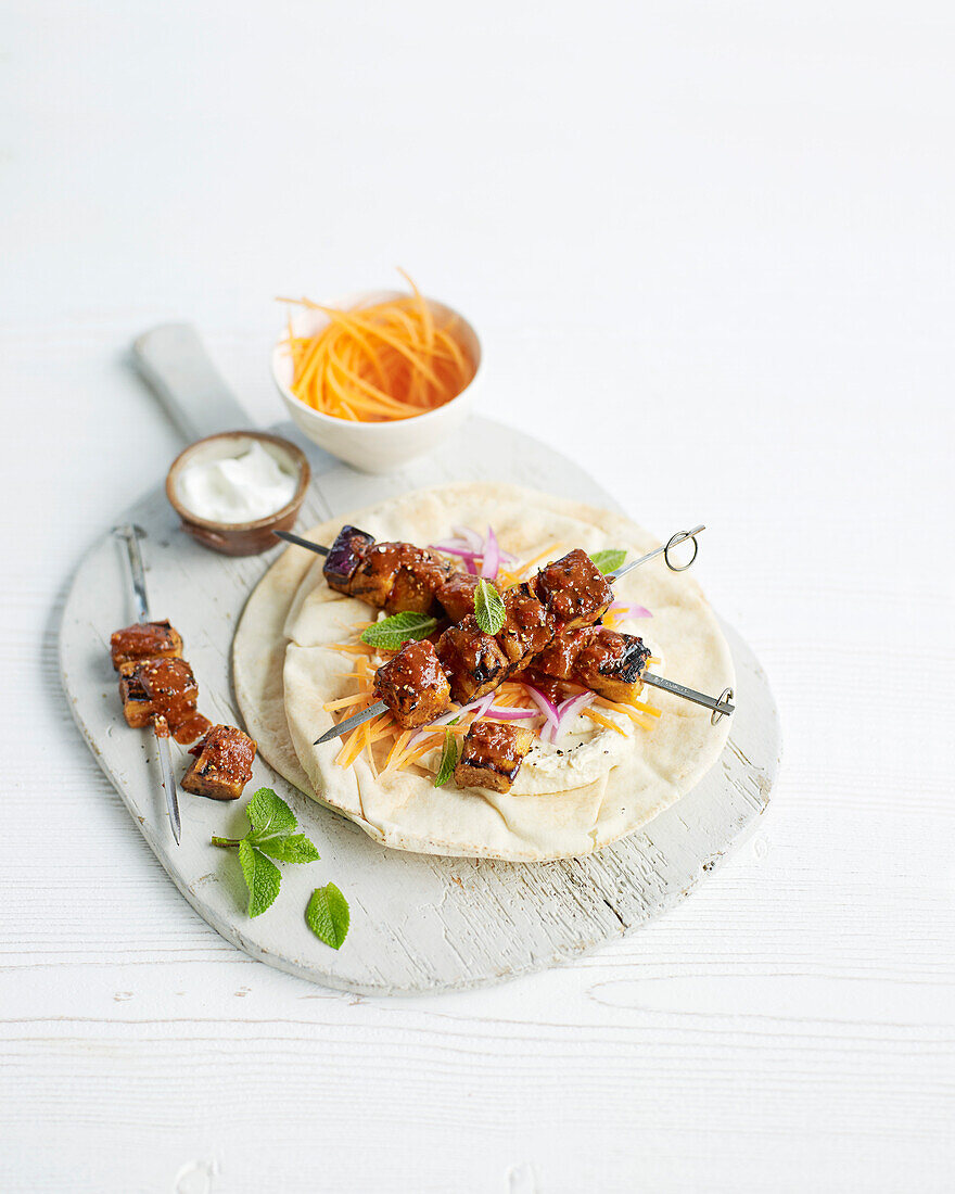 Harissa aubergine skewers with minty carrot salad