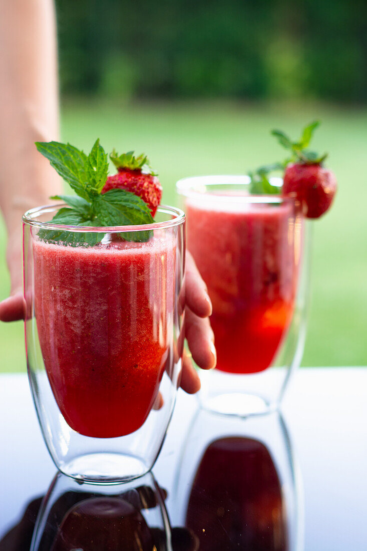 Strawberry smoothie on outdoor table