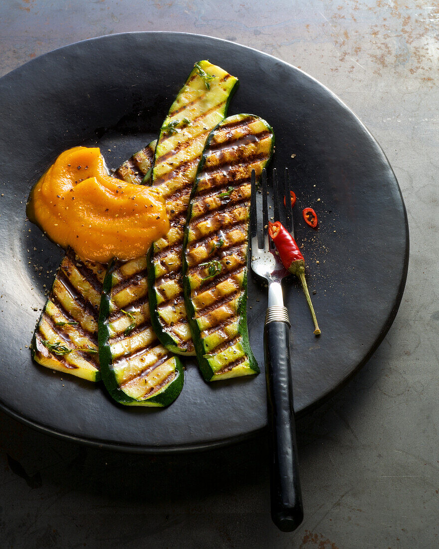 Grilled Zucchini and peppers on a black plate
