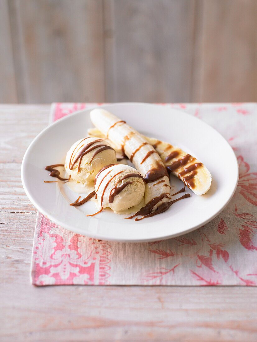 Banana with vanilla ice cream and chocolate sauce