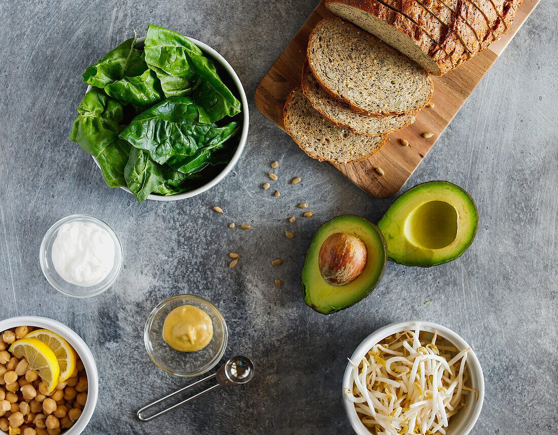 Bread, chickpeas, lettuce, avocado, and sprouts
