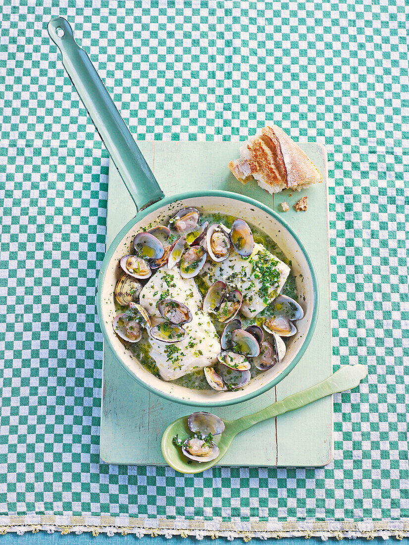 Spanish-style fish with parsley and clams