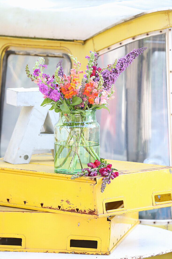 Bouquet of snapdragons in glass in a discarded gondola